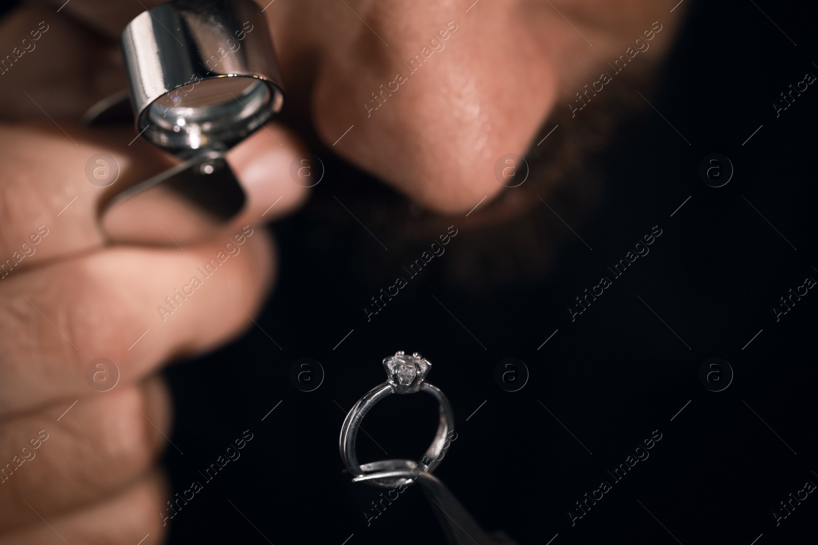 Photo of Professional jeweler working with ring, closeup view