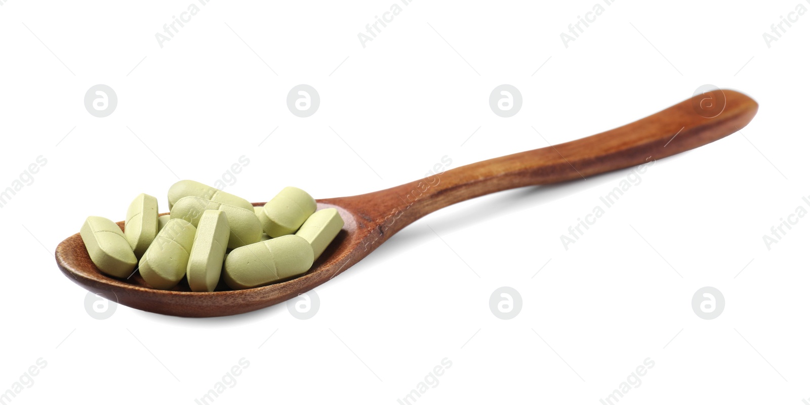 Photo of Vitamin capsules in wooden spoon isolated on white