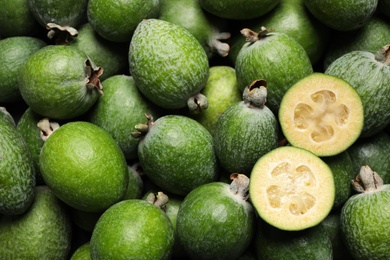 Fresh green feijoa fruits as background, closeup