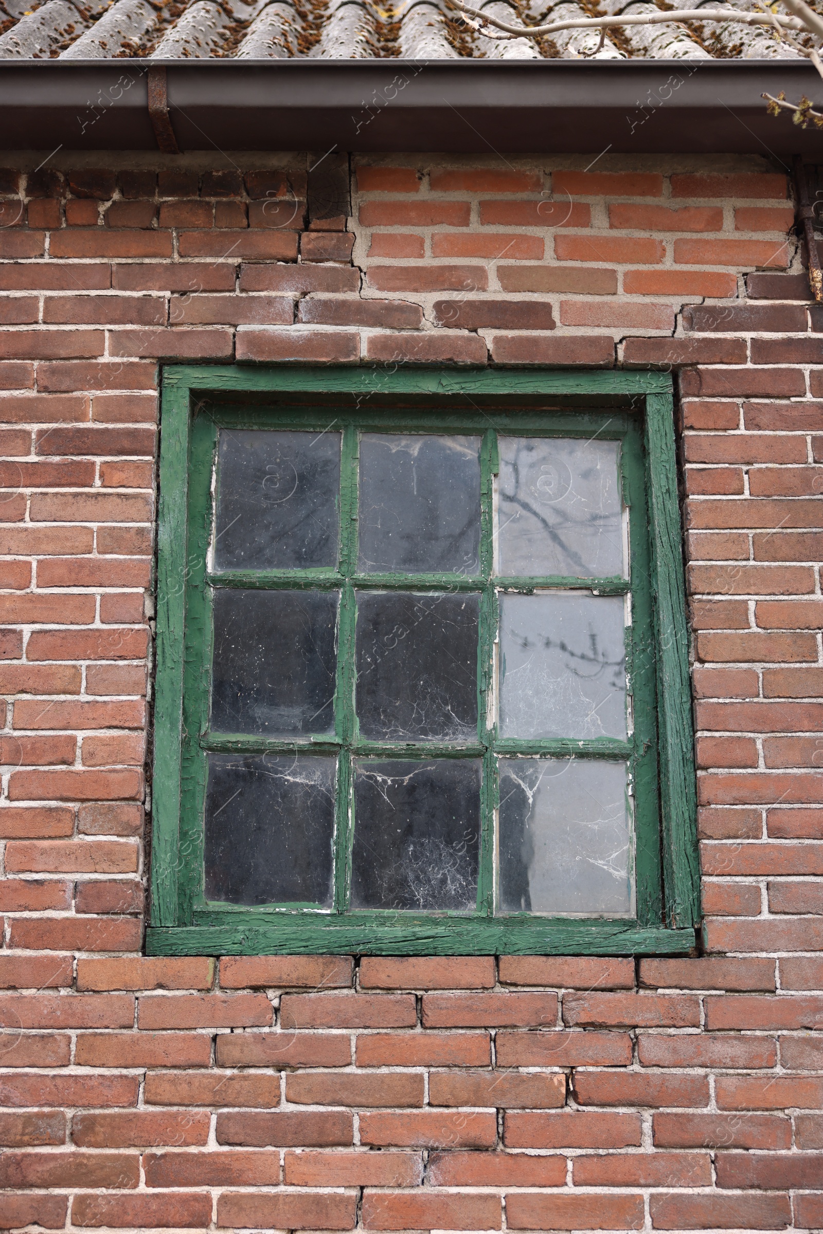 Photo of Old window with green frame in building outdoors