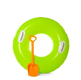 Photo of Inflatable ring and beach shovel on white background. Summer holidays