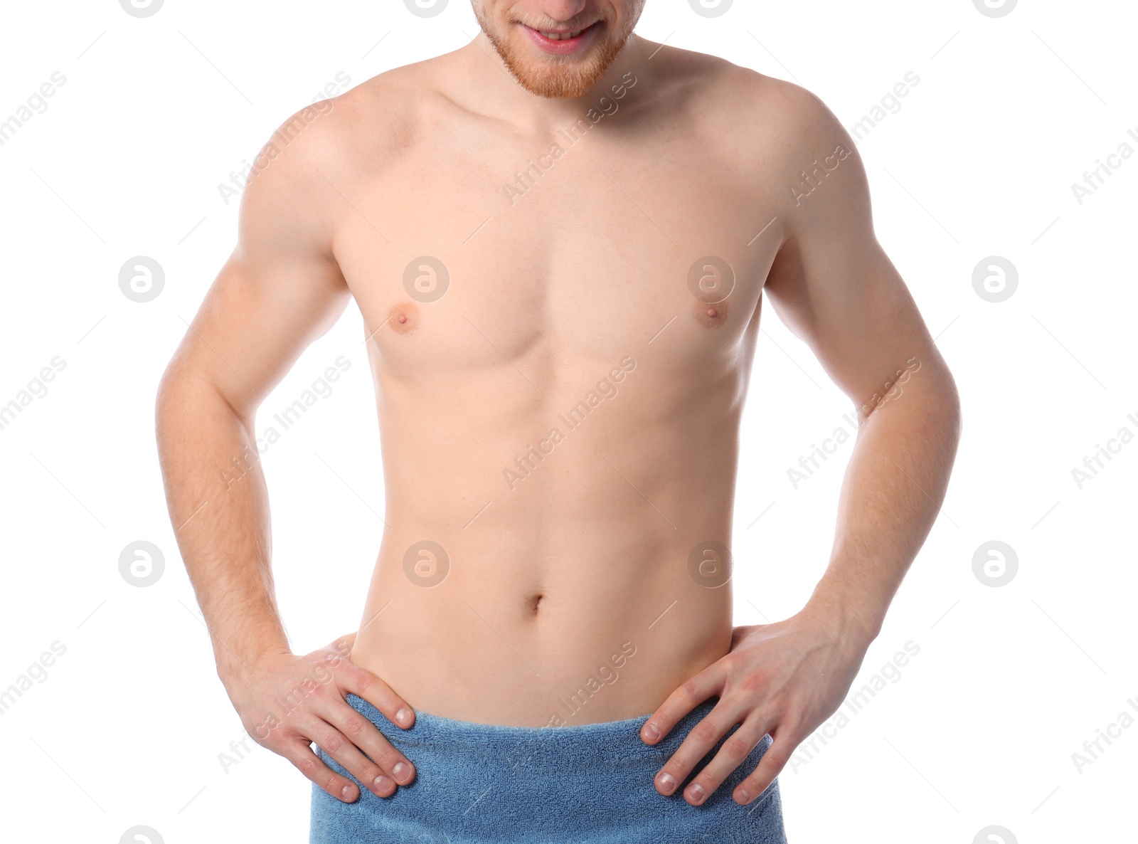 Photo of Young man with slim body in towel on white background, closeup