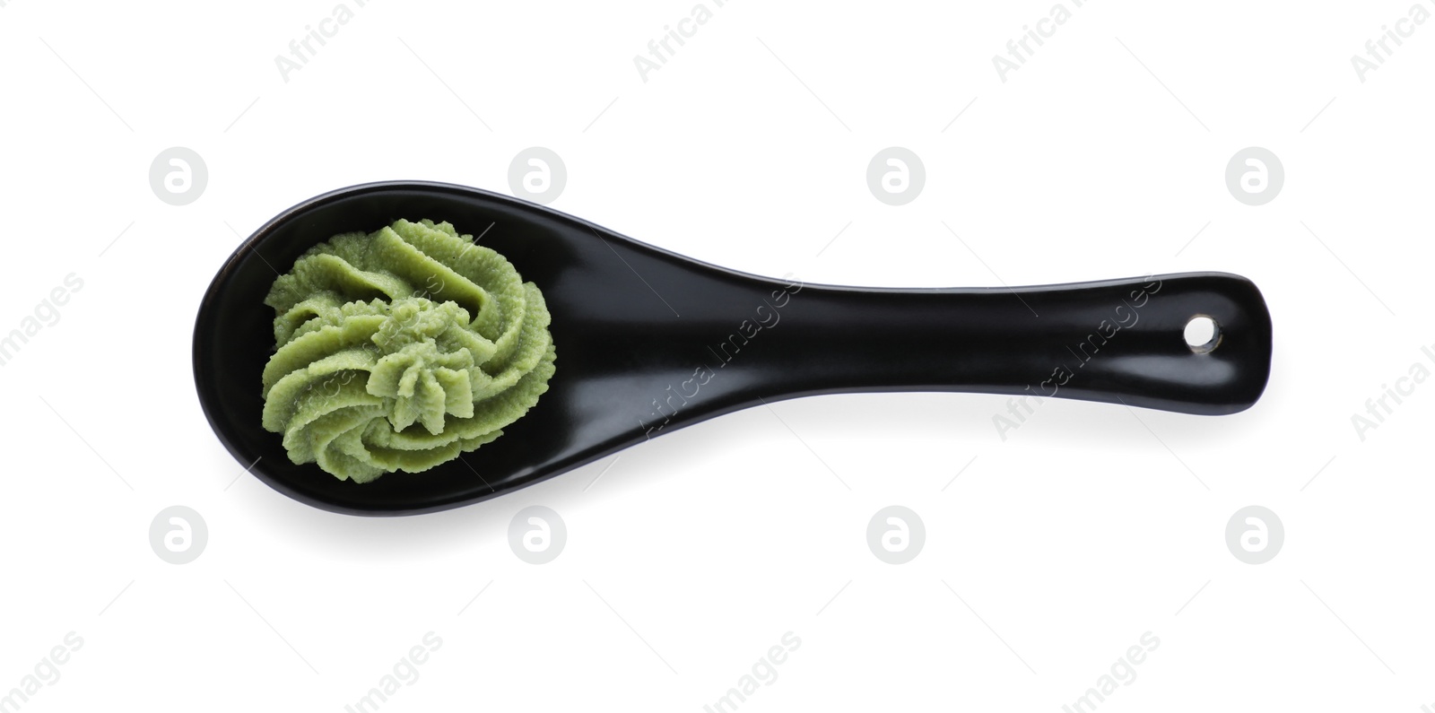 Photo of Ceramic spoon with swirl of wasabi paste isolated on white, top view