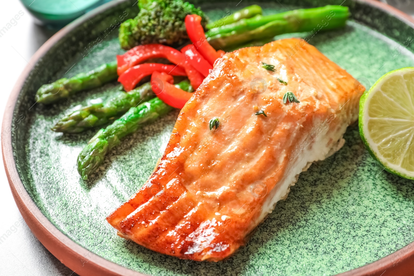 Photo of Plate with tasty freshly cooked salmon, closeup