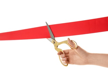 Photo of Woman cutting red ribbon on white background