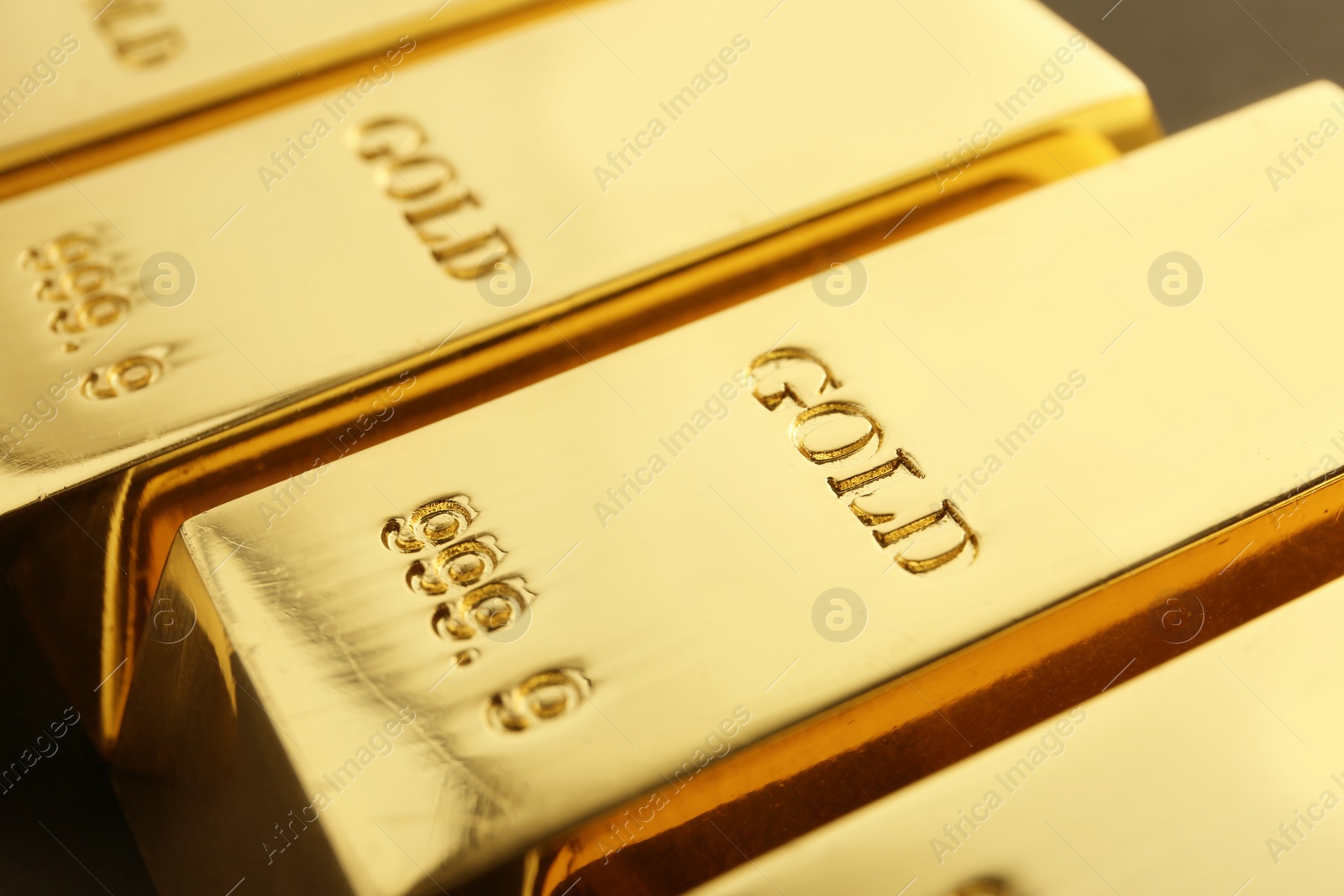 Photo of Shiny sleek gold bars as background, closeup