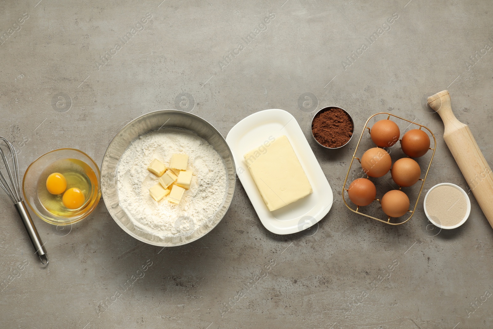 Photo of Flat lay composition with fresh butter and other products on grey textured table