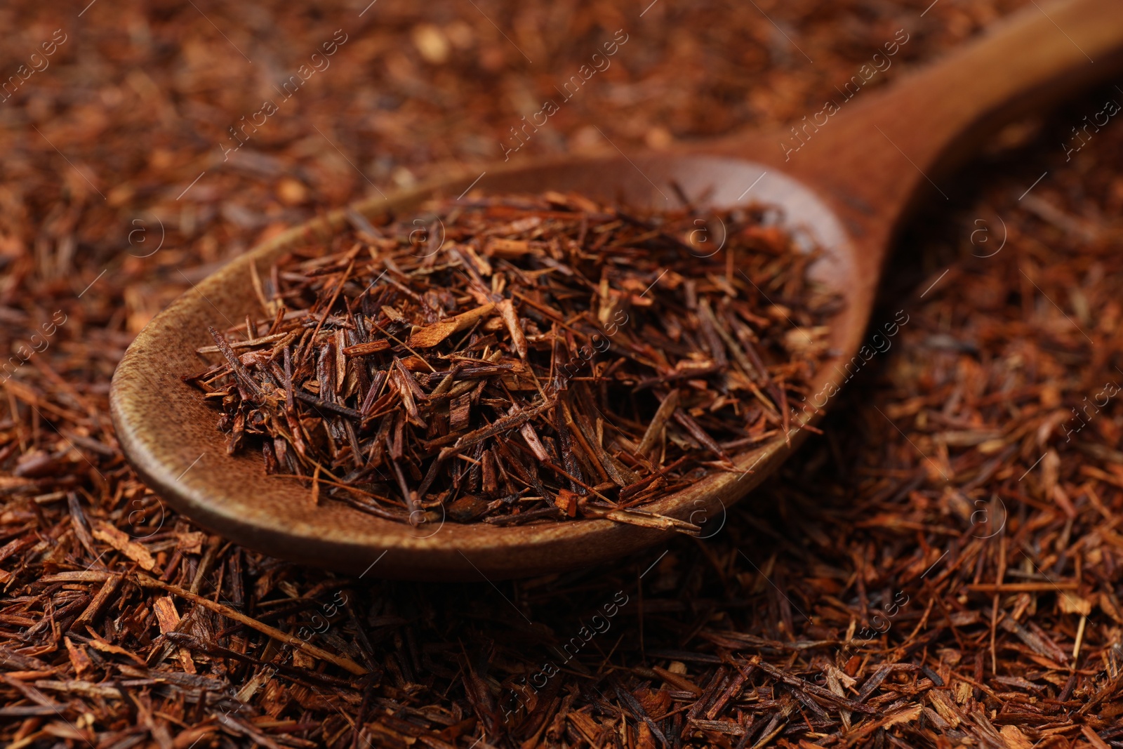 Photo of Rooibos tea and wooden spoon, closeup view