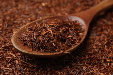 Rooibos tea and wooden spoon, closeup view