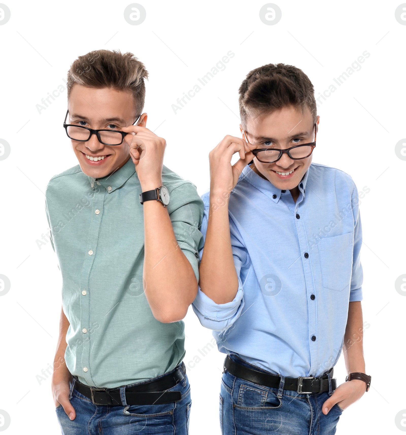 Photo of Teenage twin brothers with glasses on white background