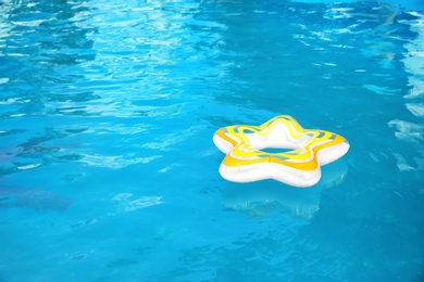 Photo of Inflatable ring floating in swimming pool on sunny day