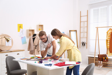 Fashion designers creating new clothes in studio