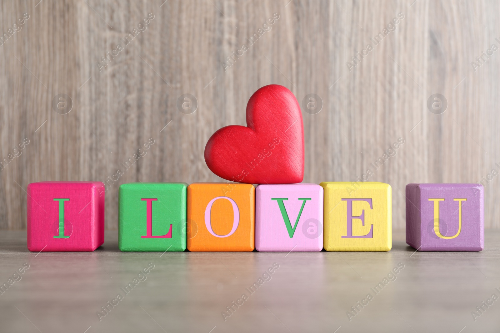 Photo of Phrase I Love You made of wooden cubes on table