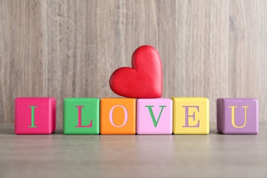 Photo of Phrase I Love You made of wooden cubes on table