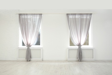 Photo of Modern windows with curtains in room. Home interior