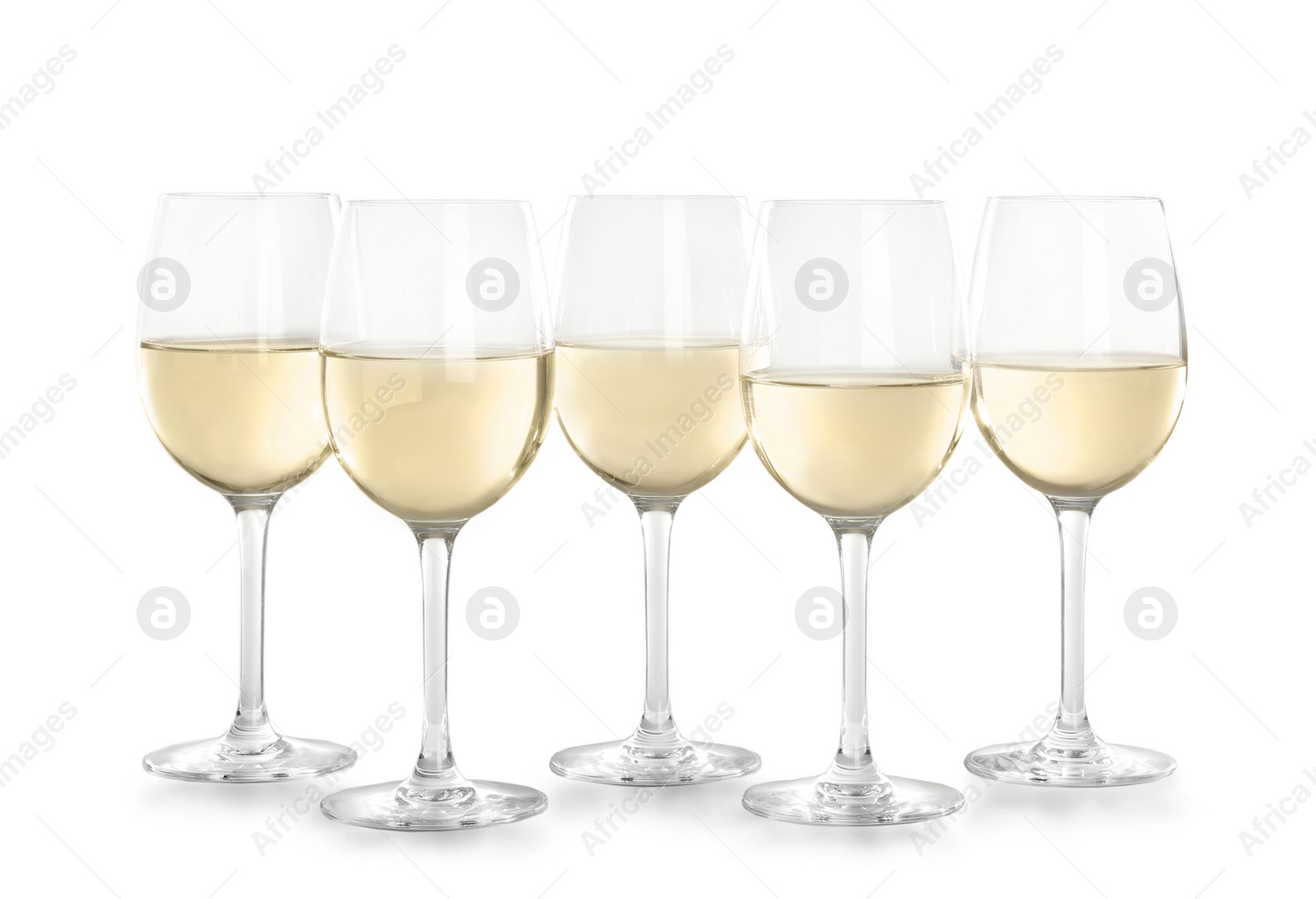 Photo of Glasses with white wine on light background