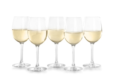 Photo of Glasses with white wine on light background