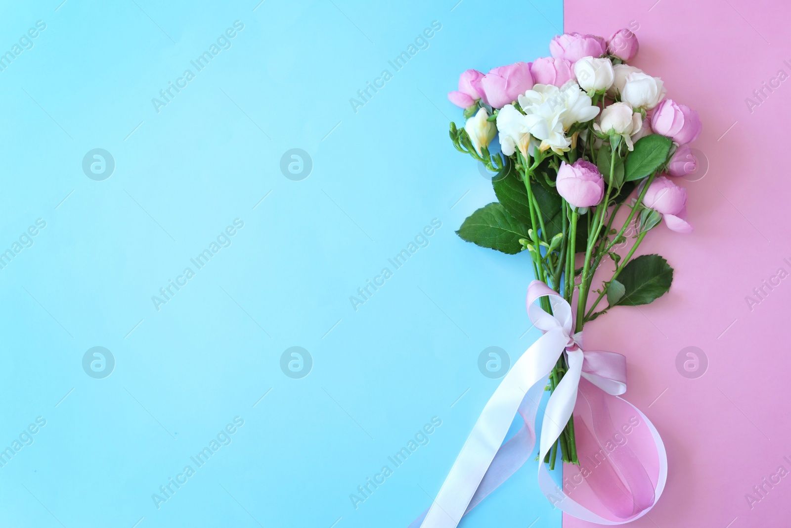 Photo of Bouquet of beautiful flowers on color background, top view