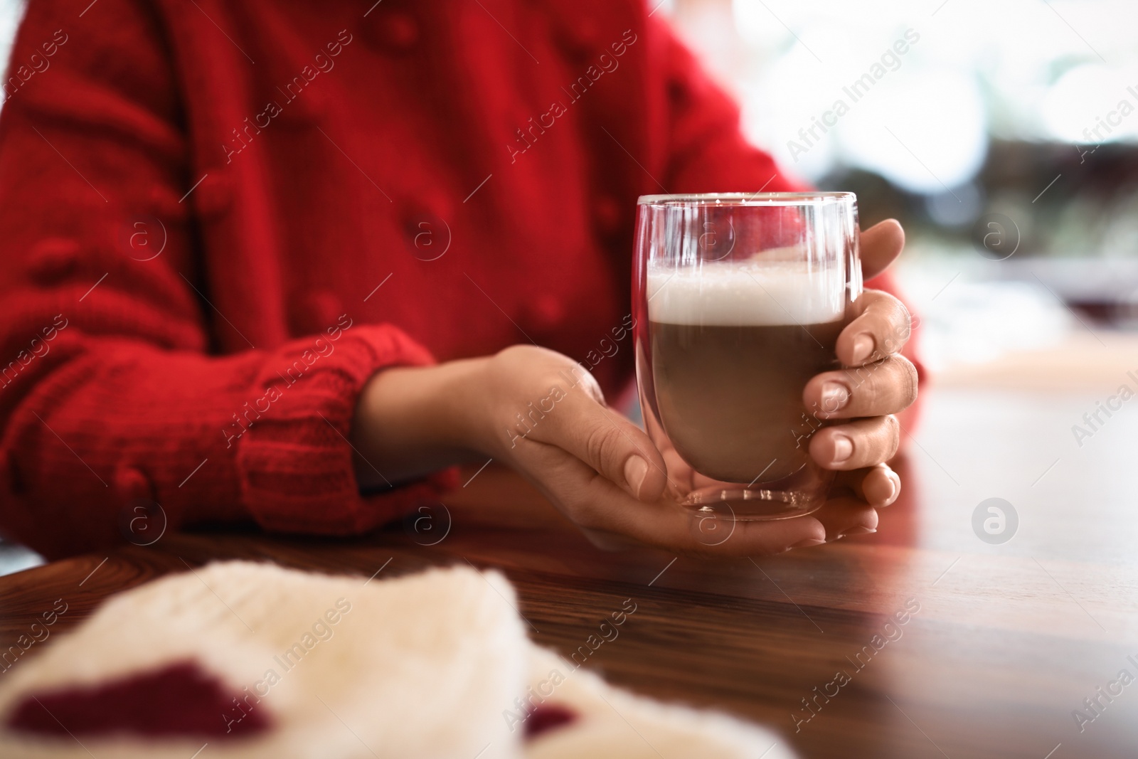Photo of Woman with fresh aromatic coffee at table in cafe, closeup