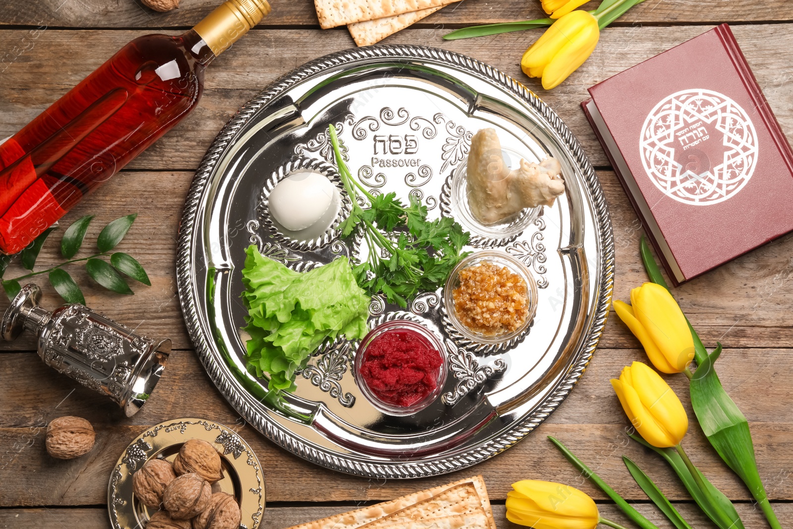Photo of Flat lay composition with symbolic Passover (Pesach) items on wooden background