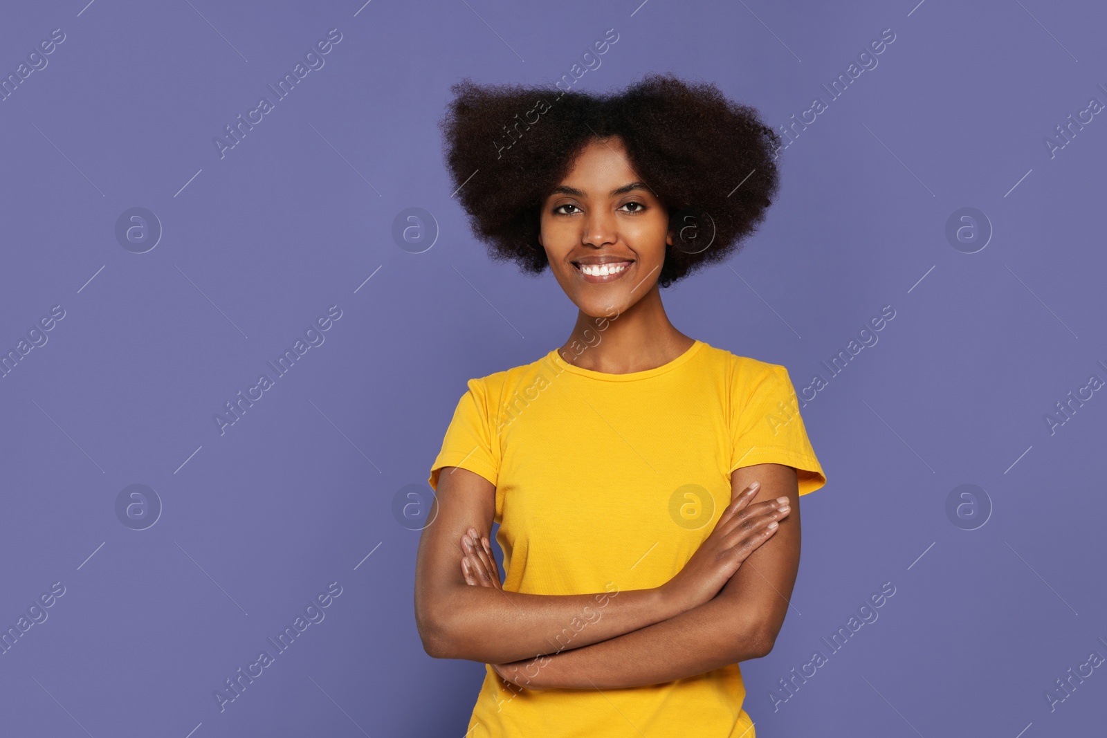 Photo of Portrait of smiling African American woman on purple background. Space for text