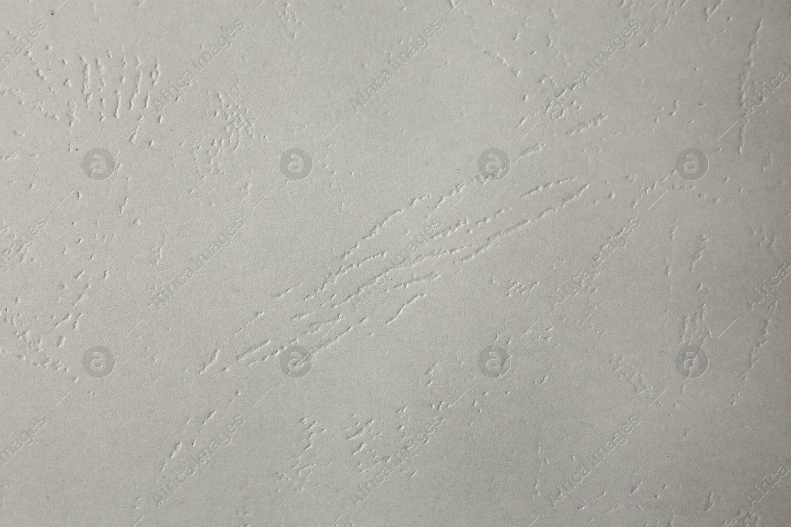 Photo of Texture of light grey paper sheet as background, closeup