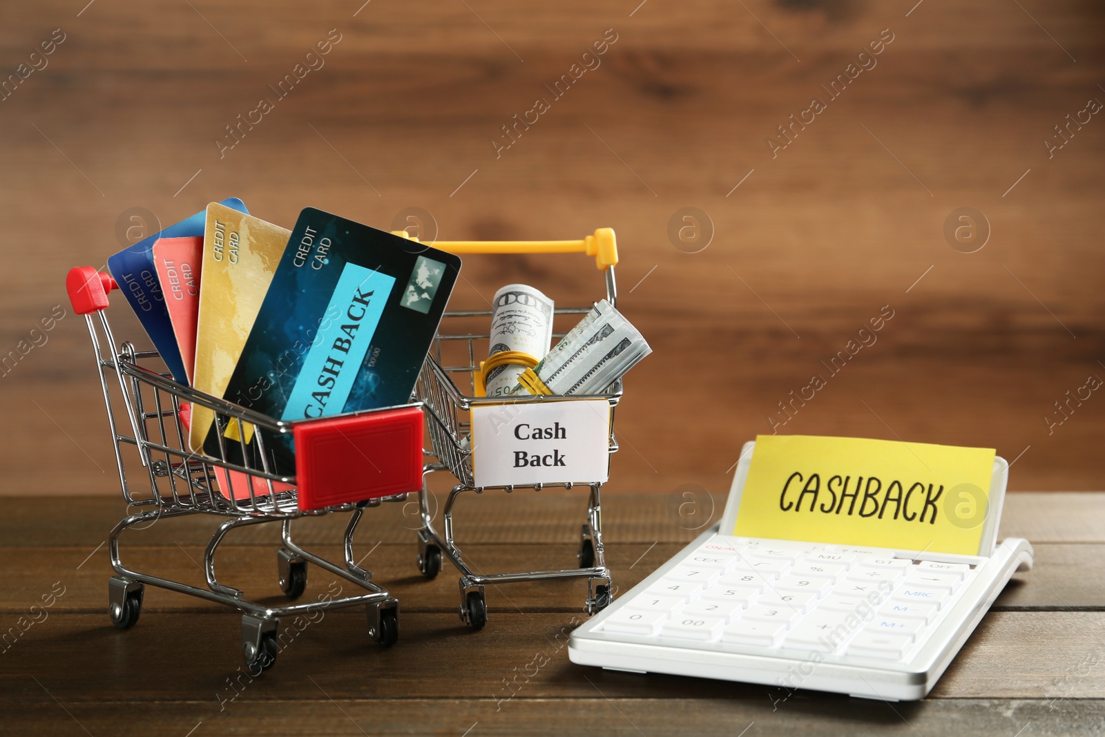 Photo of Composition with signs Cash Back, credit cards and calculator on wooden table