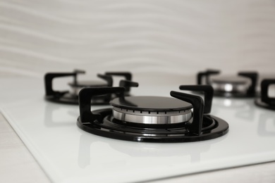 Photo of Modern built-in gas cooktop, closeup. Kitchen appliance