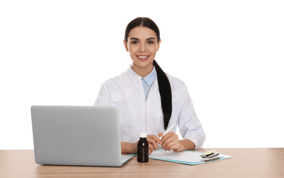 Professional pharmacist working at table against white background