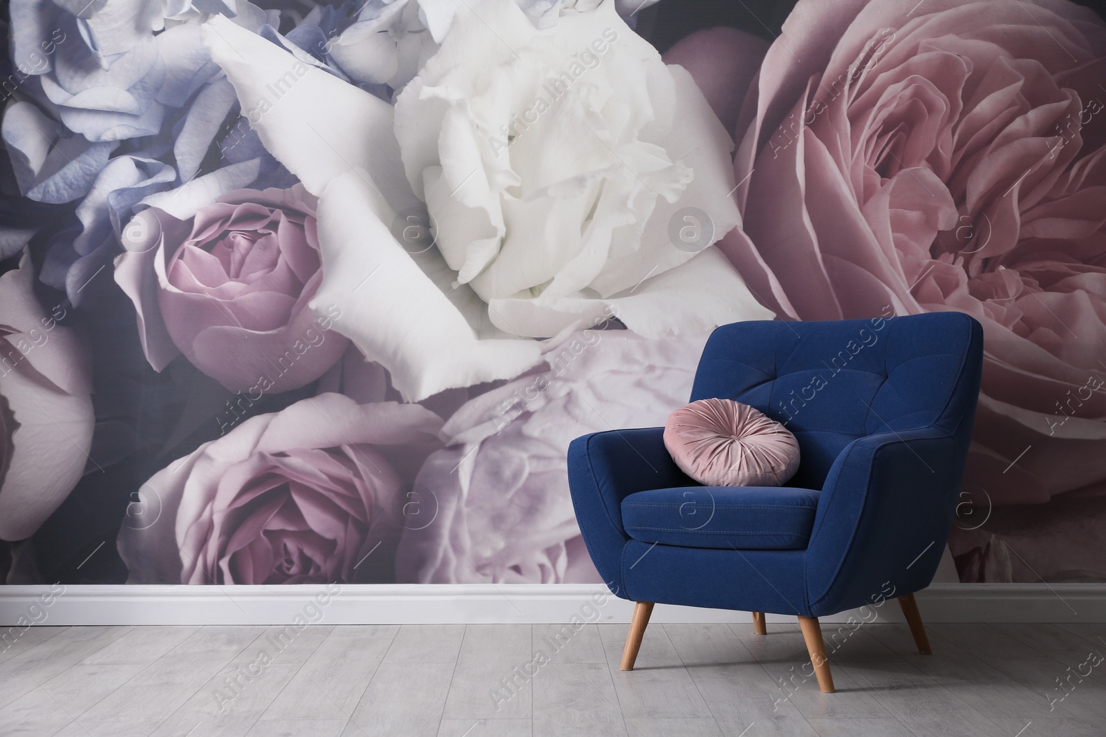 Photo of Comfortable armchair near wall with floral wallpaper, space for text. Stylish living room interior