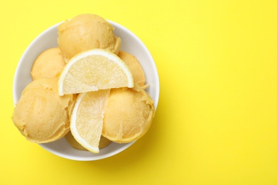 Delicious lemon ice cream on yellow background, top view. Space for text