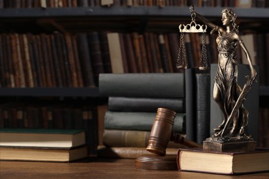 Law. Statue of Lady Justice, gavel and books on wooden table indoors