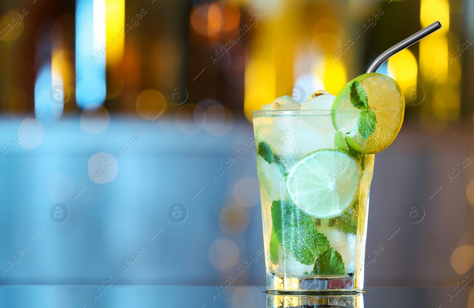 Photo of Glass of fresh alcoholic cocktail on bar counter. Space for text