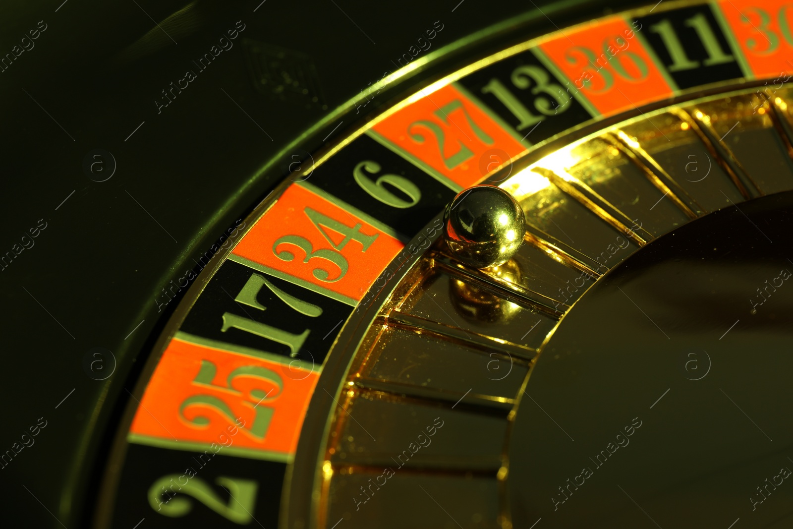 Photo of Roulette wheel with ball, closeup. Casino game