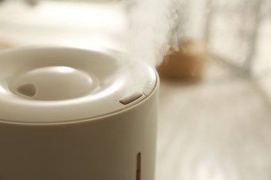 Photo of Modern humidifier indoors, closeup. Space for text