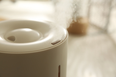 Modern humidifier indoors, closeup. Space for text