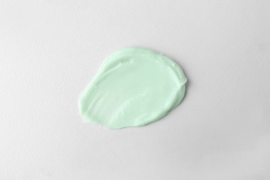 Sample of hand cream on white background, top view