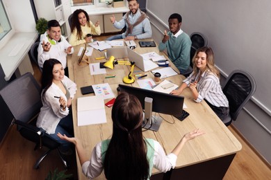 Photo of Team of employees working together in office. Startup project