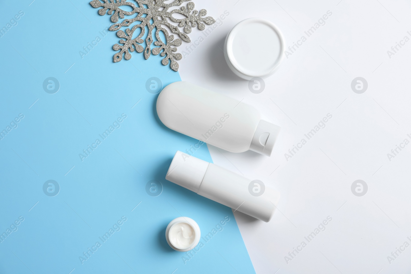 Photo of Set of cosmetic products on color background, flat lay. Winter care