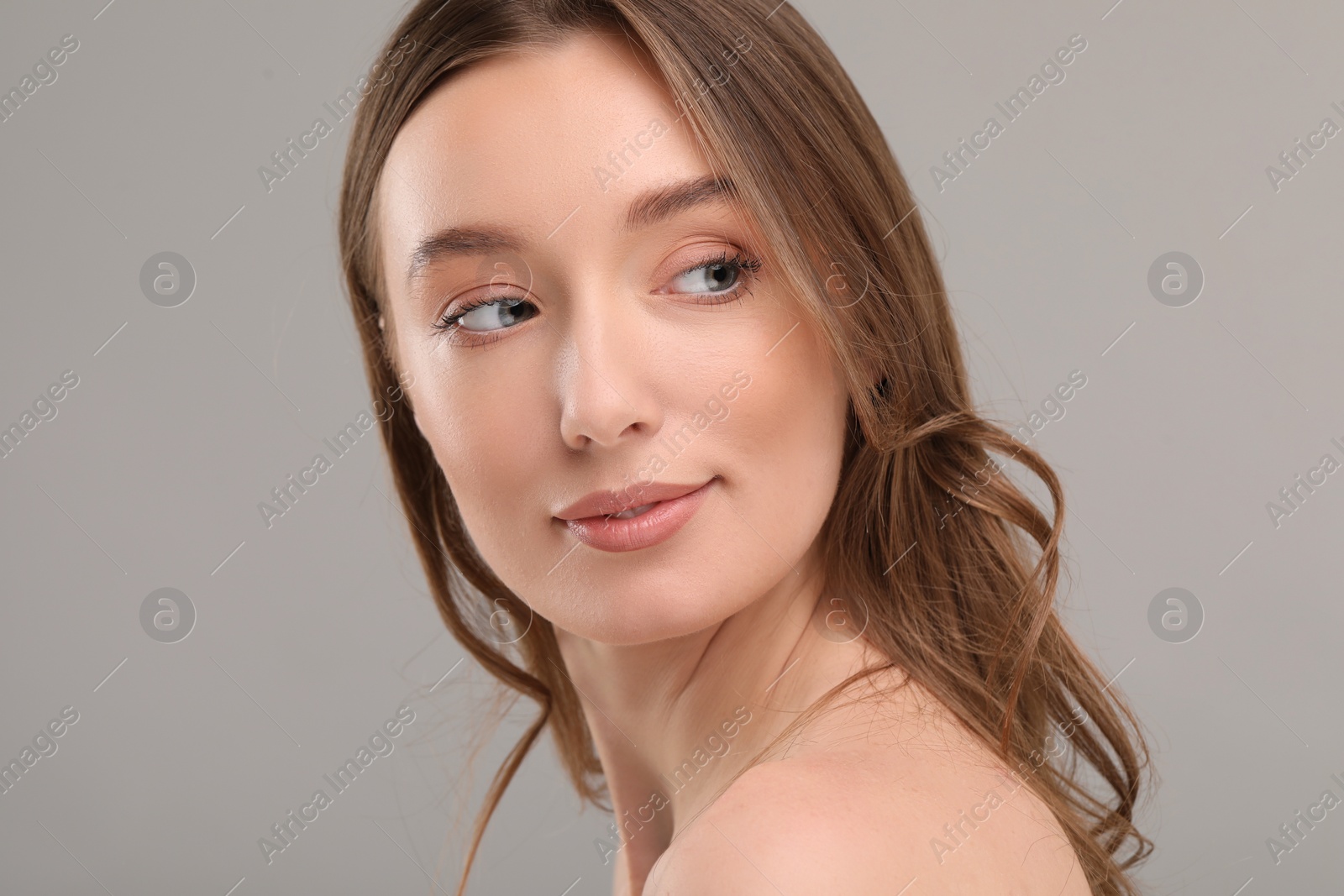 Photo of Beautiful woman with healthy skin on gray background