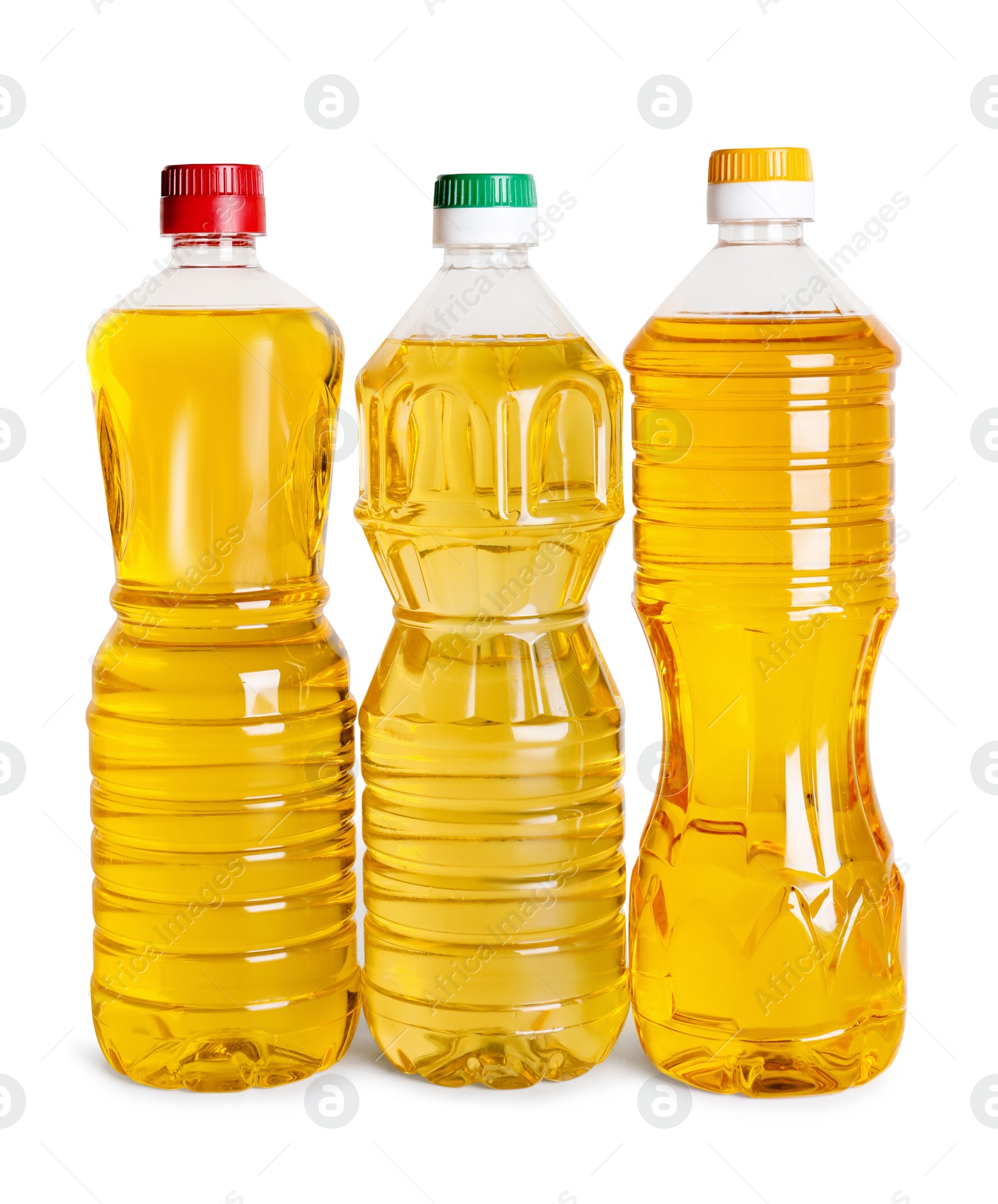 Photo of Bottles of cooking oil on white background