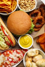 Photo of Burger, pizza and other fast food as background, top view