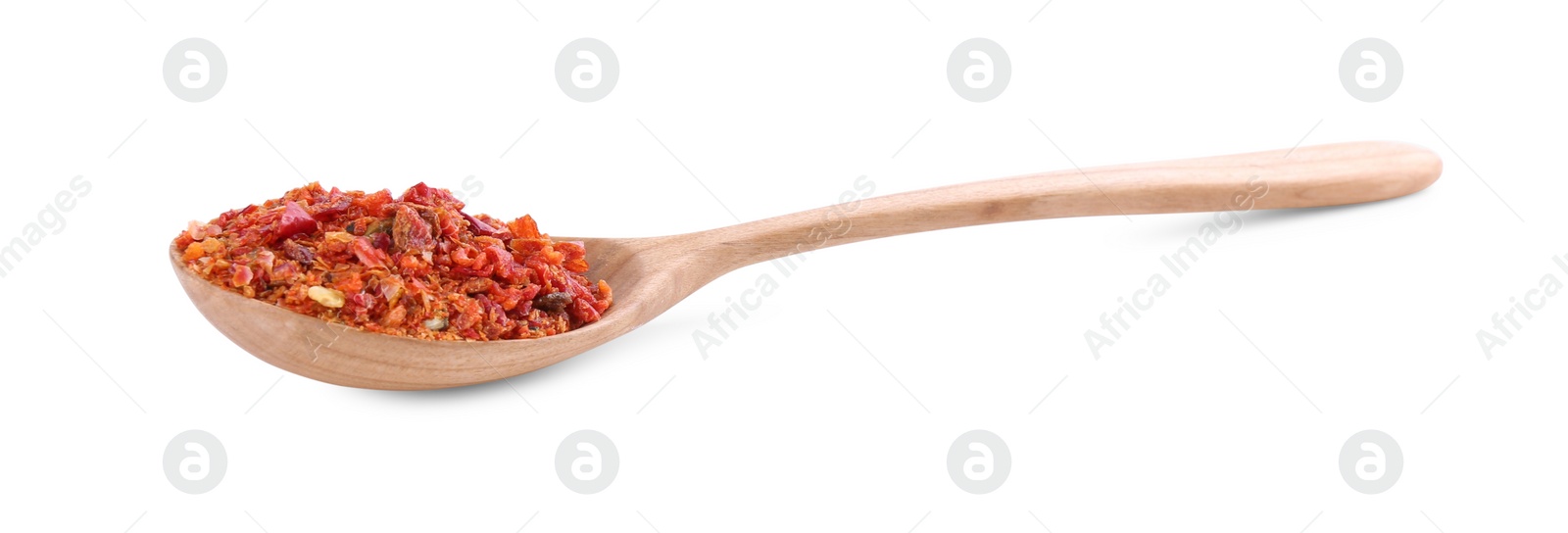 Photo of Aromatic spice. Red chili pepper flakes in spoon isolated on white