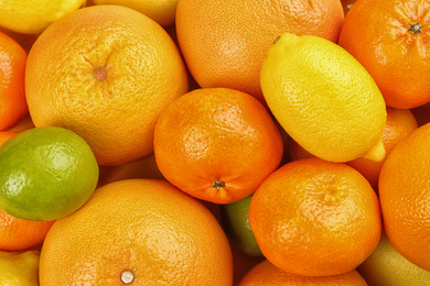 Photo of Tangerines, oranges, lime and lemon as background, top view