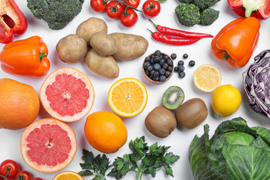 Photo of Different products rich in vitamin C on white background, top view