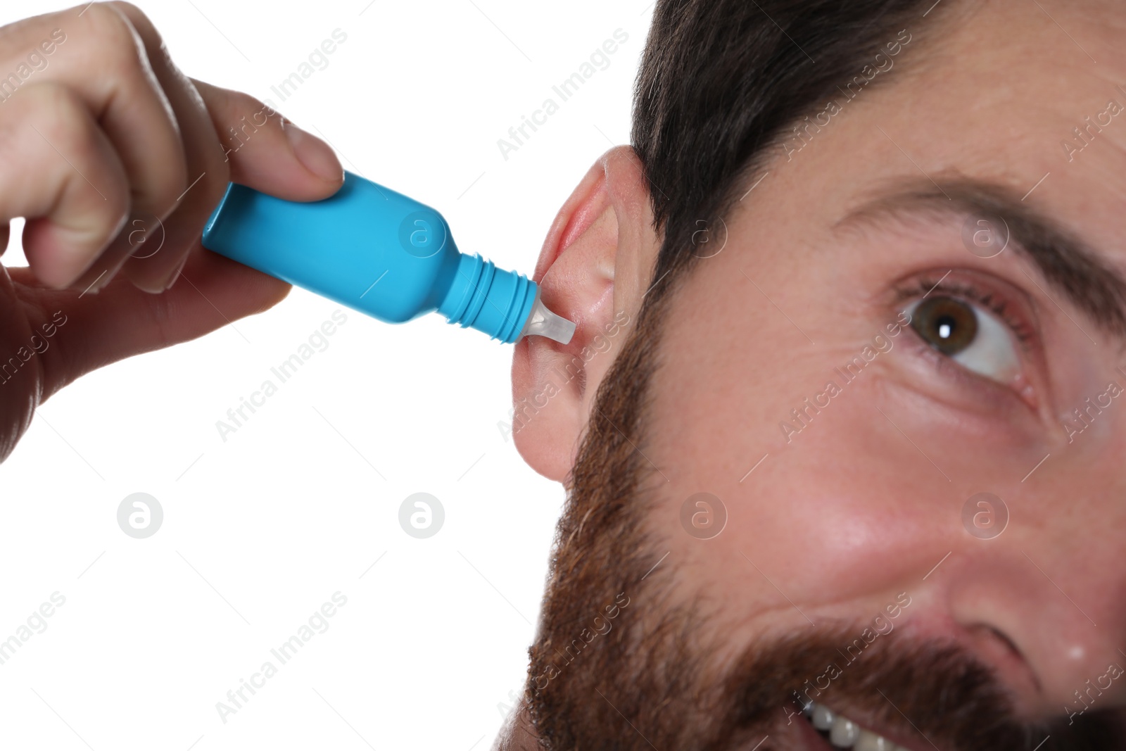 Photo of Man using ear drops on white background, closeup