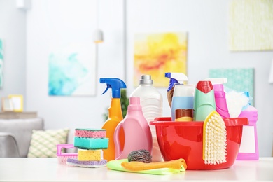 Photo of Set of cleaning supplies on table indoors