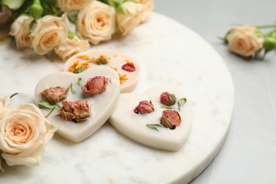 Scented sachets and flowers on light grey table