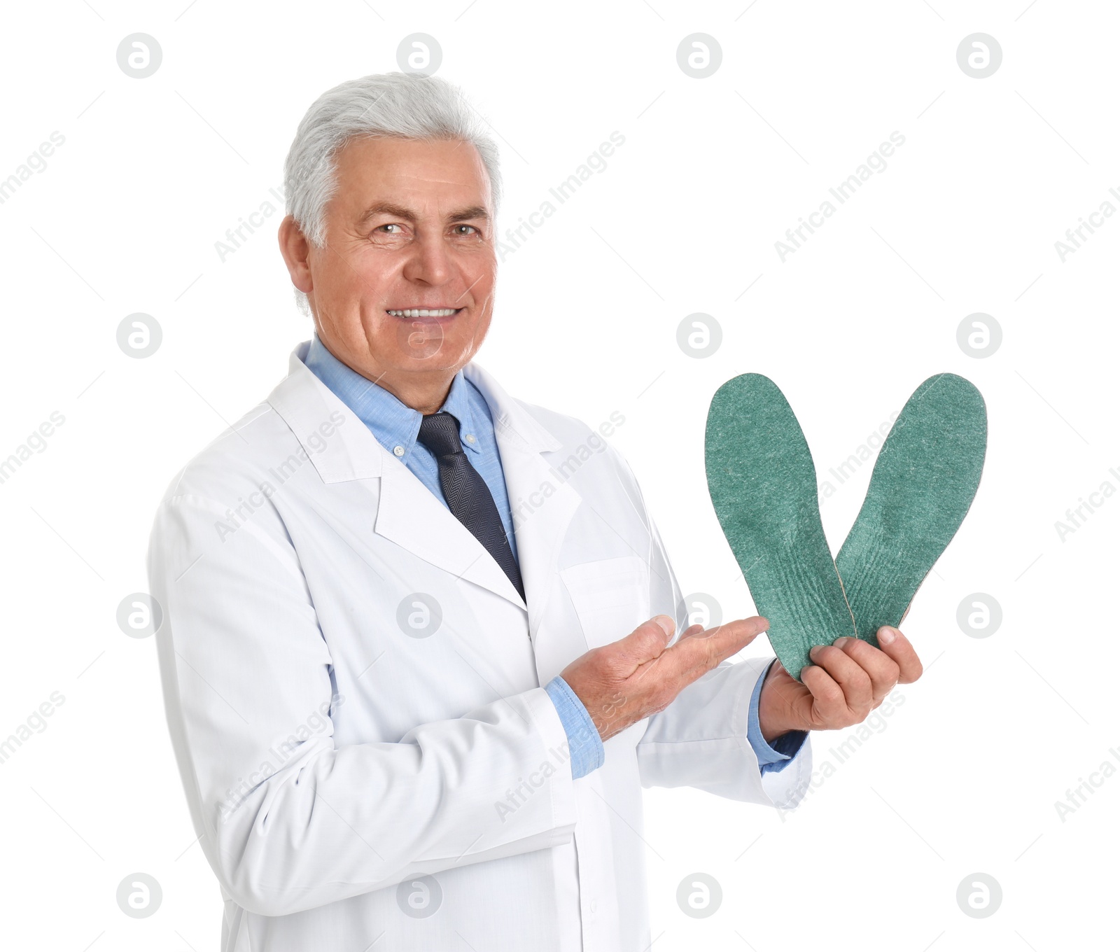 Photo of Male orthopedist showing insoles on white background