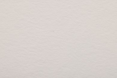 Photo of Texture of light grey paper sheet as background, top view